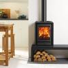 Compact Stovax Riva2 40 multi-fuel stove on log store base in modern living room