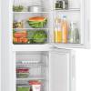 Interior view of Bosch KGN27NWEAG fridge freezer with glass shelves and freezer drawers