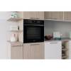 Lifestyle image of Indesit IO253BUK oven installed in a modern black kitchen setting