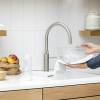 Stainless steel Quooker Fusion Round Tap delivering hot, cold, boiling, chilled and sparkling water