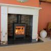 Woodford Pankhurst 5kW stove installed in living room with flue pipe