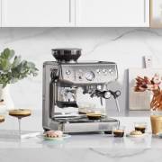 Front view of Sage Barista Express Impress espresso machine in stainless steel finish