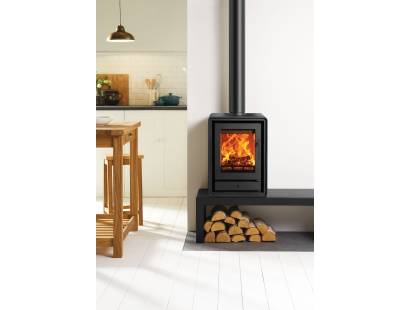 Compact Stovax Riva2 40 multi-fuel stove on log store base in modern living room
