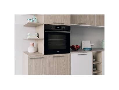 Lifestyle image of Indesit IO253BUK oven installed in a modern black kitchen setting