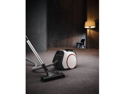 Miele vacuum in use on tile, carpet, and laminate floors