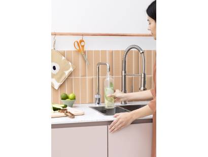 Showing the Quooker Nordic Square Polished Chrome Single Tap being used to fill a bottle