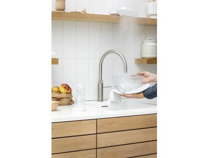 Stainless steel Quooker Fusion Round Tap delivering hot, cold, boiling, chilled and sparkling water